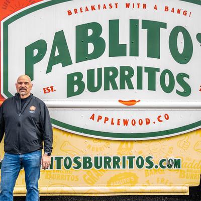 The owner posing in front of the truck.