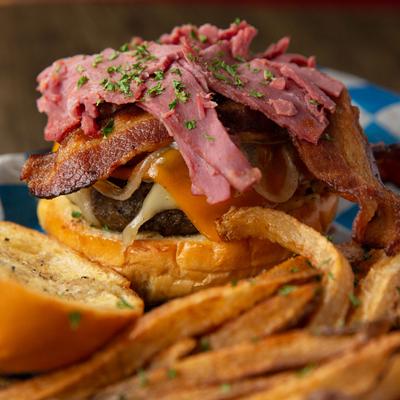 Burger with melted cheese and bacon, fries on the side