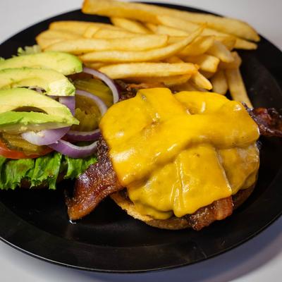 Avocado bacon cheeseburger and fries.