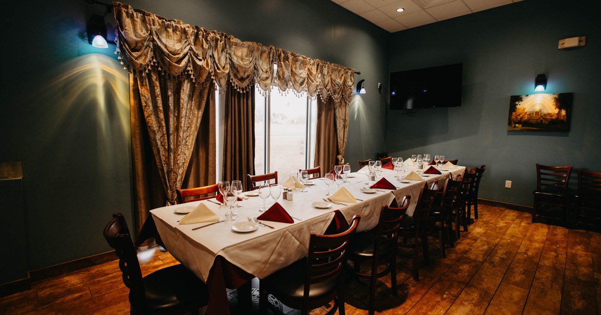Interior, long dining table ready for guests