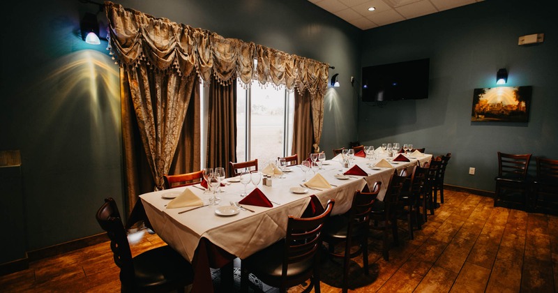 Interior, long dining table ready for guests