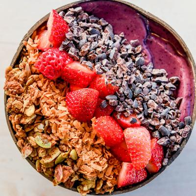 Acai bowl, with mixed berries, nuts, banana, mango, and pineapple.