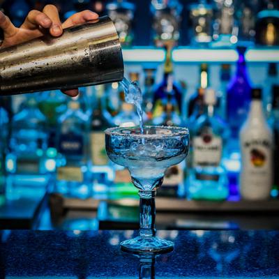 A hand pouring a drink.