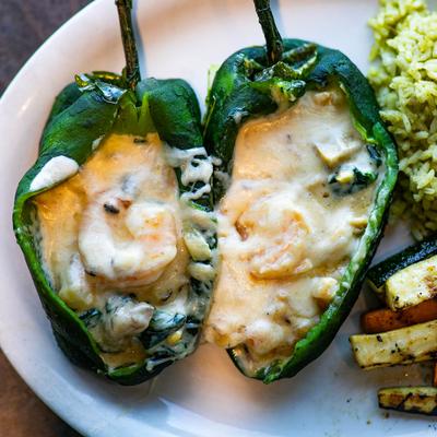 Chile Relleno Shrimp, served with cilantro rice and grilled seasonal vegetables.