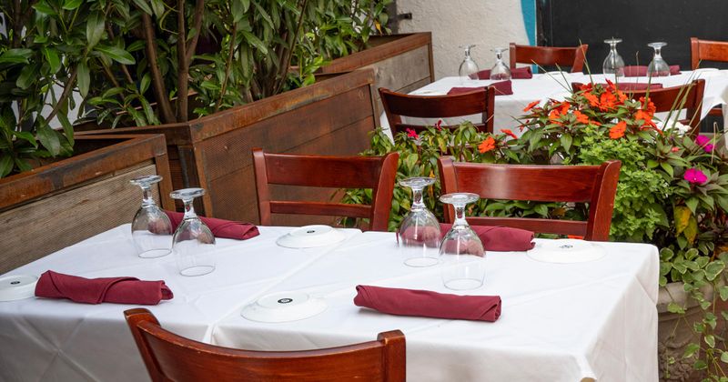 Elegantly set tables with dark red serviettes
