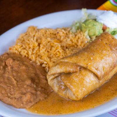 Chimichanga served with rice, beans, lettuce, guacamole and sour creme.