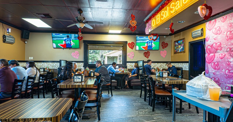 Interior, dining area with TV screens