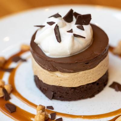 Chocolate cake dessert with white cream and decorations