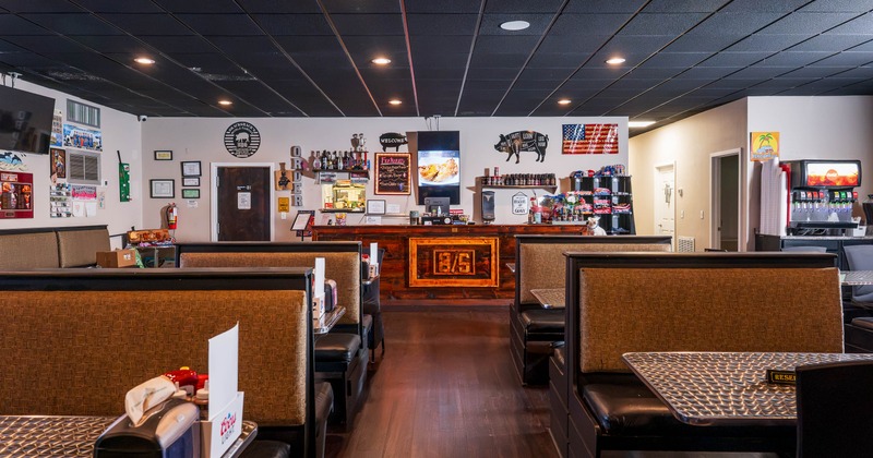 Casual restaurant interior with brown booths and a wooden counter