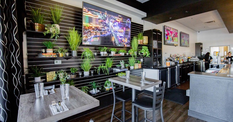 Interior, tables and chairs, plants on the wall