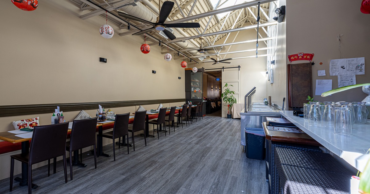 Spacious interior dining area with dining tables lined up along the wall