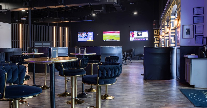 Interior, high seating area, round tables with stools, lounge area in the back