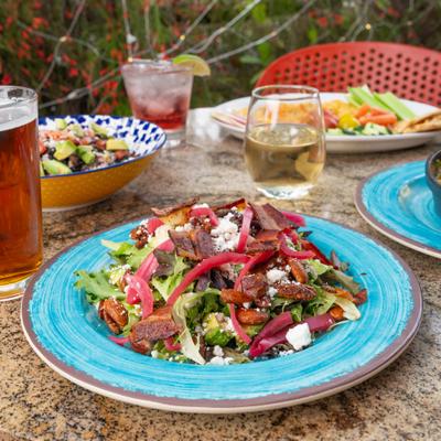 Salad with mixed greens, bacon, goat cheese, and pickled red onion.