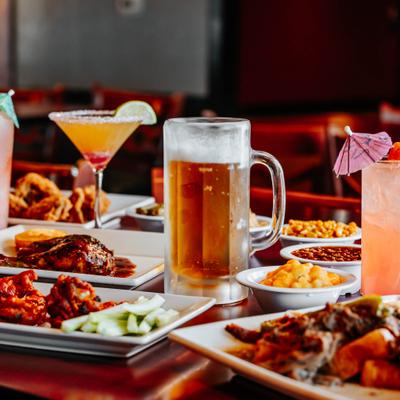 Restaurant table filled with assorted dishes and drinks.