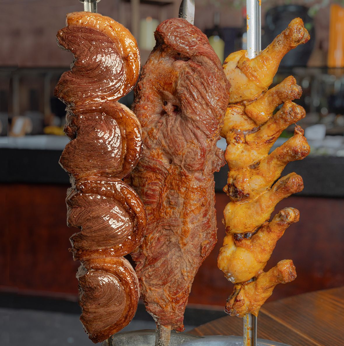 Various grilled meats on skewers in a restaurant