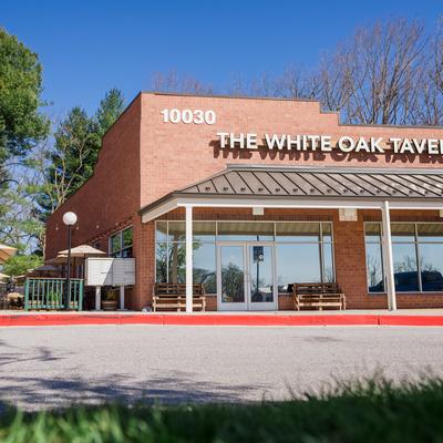 Brick restaurant exterior beneath a clear blue sky.