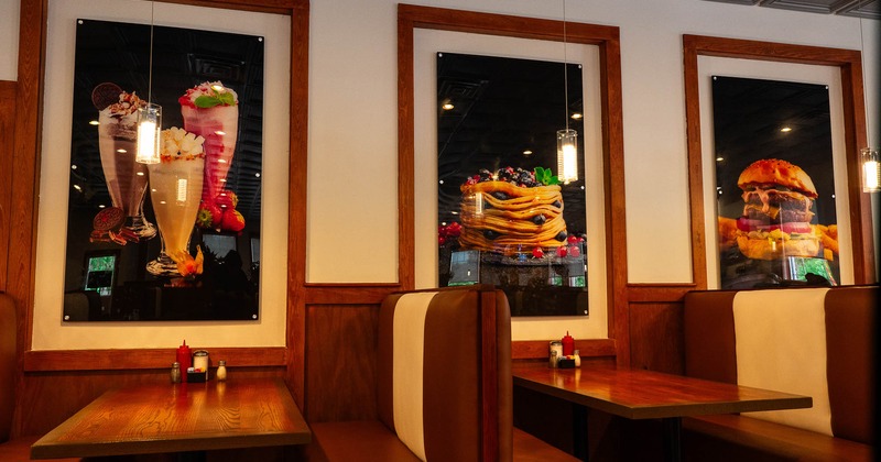 Interior, booths all lined up with pictures on the wall