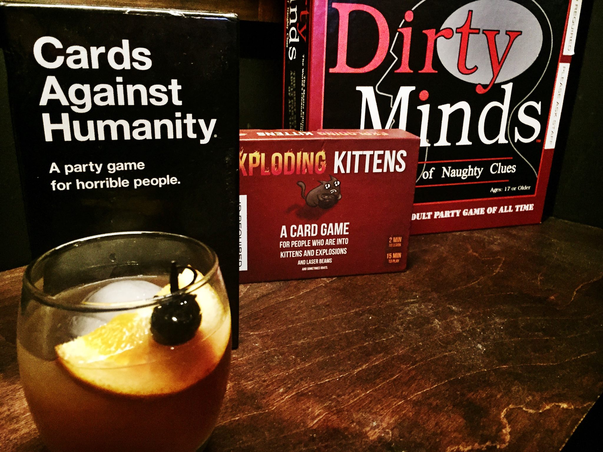 Various board games and an Old Fashioned cocktail.