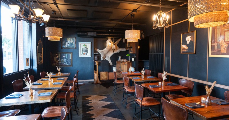 Interior, dining area with tables, chairs and decoration on the wall