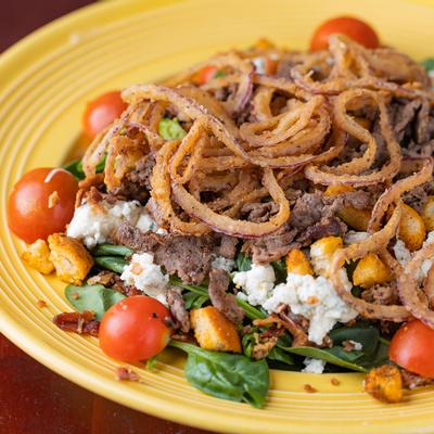 Grilled sliced meat, mixed vegetables and onions