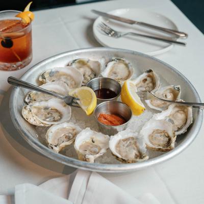 Oysters on the half shell accompanied with Old Fashioned.