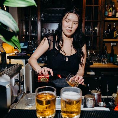 A bartender pouring beer.
