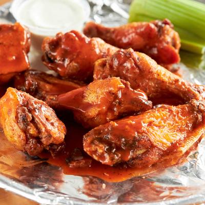 Buffalo wings with celery and dressing.