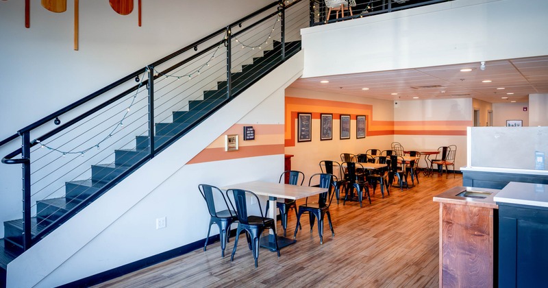 Interior, tables and chairs near stairs