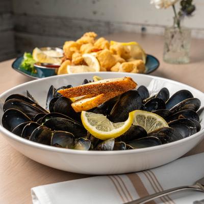Mussels in a sauce with toasted bread.