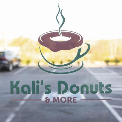 Logo on the glass, parking lot behind.