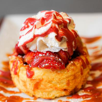 Strawberry shortcake with whipped cream and strawberry sauce.