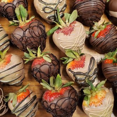 Strawberries dipped in milk and dark chocolate, close up.
