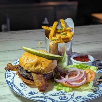 Bacon burger with fries.