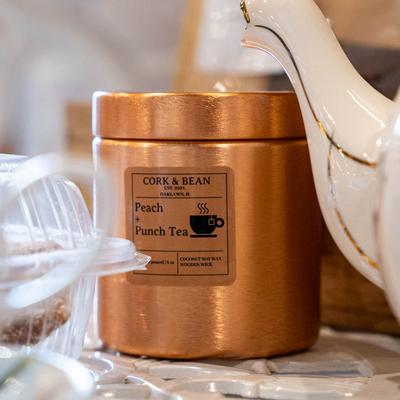 Cork and Bean Peach and Punch tea tin on a table.