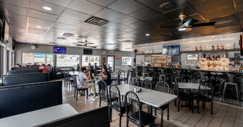Interior, booths on the left and tables and chairs on the right ready for guests