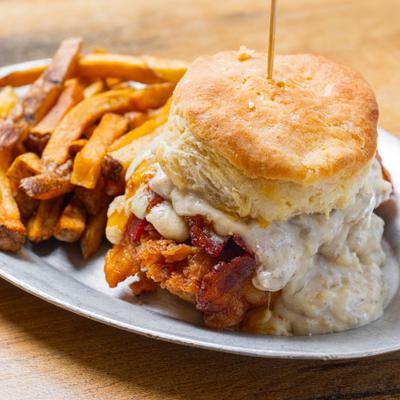 Waccamaw biscuit sandwich with gravy and fries on the side.