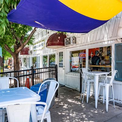 Exterior, tables and chairs in front the restaurant, parasols
