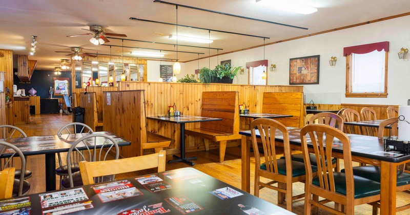 Interior, seating area with wooden tables, chairs and booths