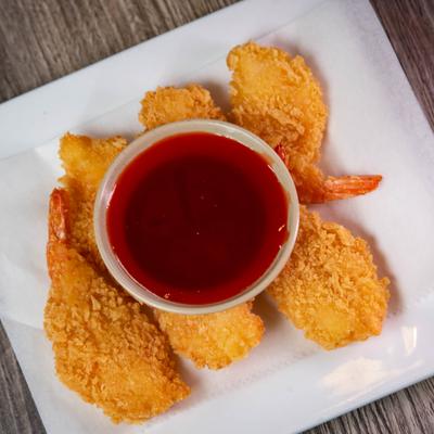 Golden crispy shrimp served with a dipping sauce.