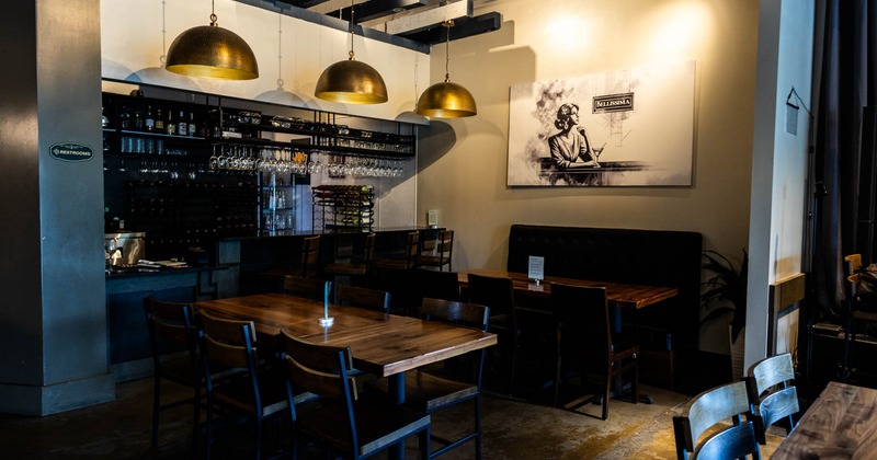 Interior, seating area, tables with chairs, a bar in the back