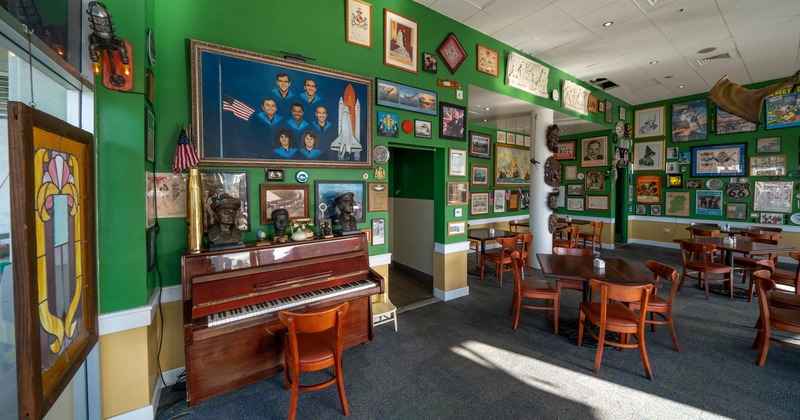 Interior, tables and chairs, piano by the wall