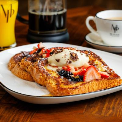 French toast topped with berries and cream.