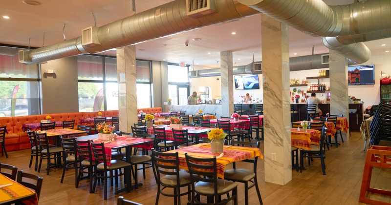 Dining room with colorful table runners, a counter area and festive accents