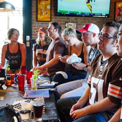 A group sitting at the table, drinking, hanging around