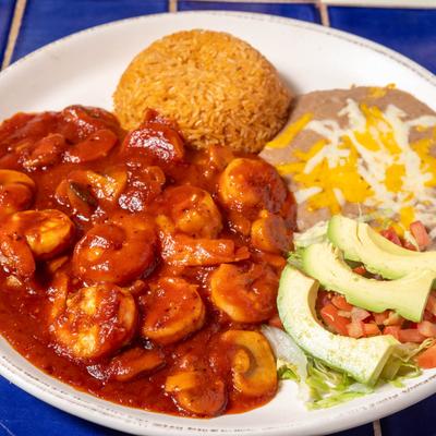 Shrimp a la Diabla, served with refried beans, rice, and avocado.