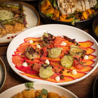 Salmon Beet Carpaccio with cheese dip, rolled cucumber and fried capers.