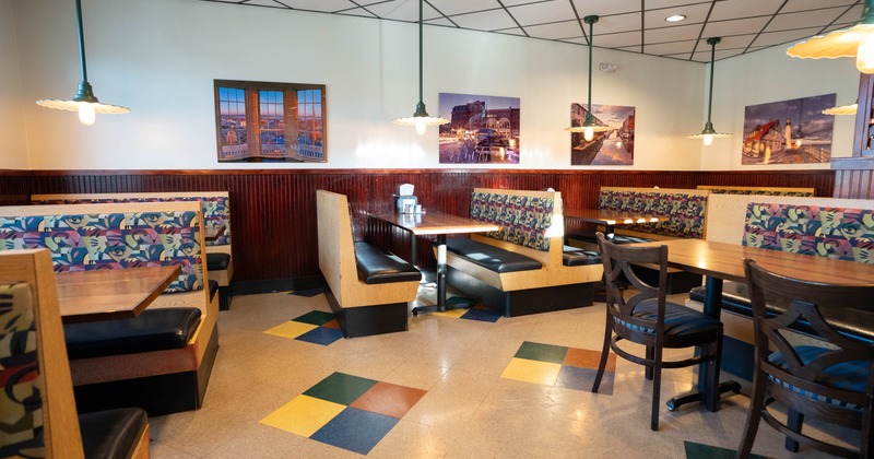 Interior, dining area, seating booths with wooden top tables, tile flooring