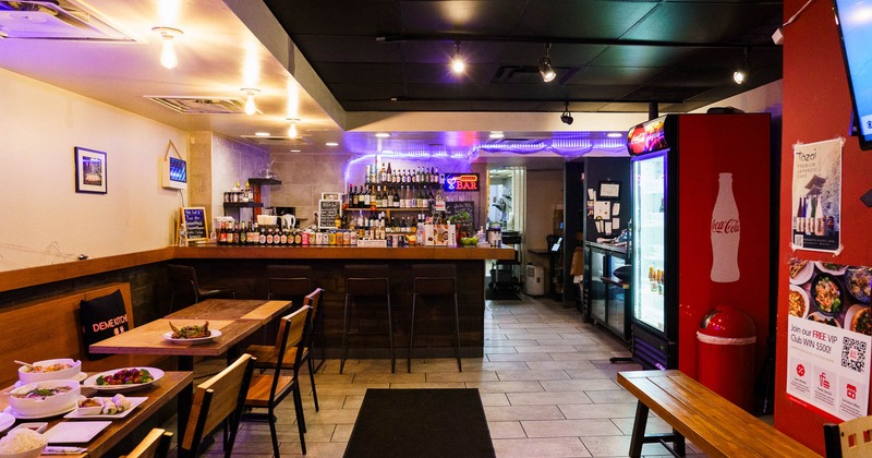 Interior, tables with chairs and a bar in the back