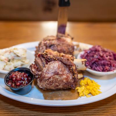 Slow roasted pork shank with sides.