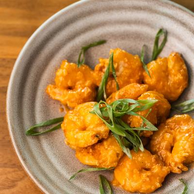 Bang Bang Shrimp garnished with sliced green onion.